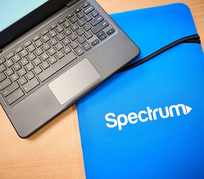 Laptop and mouse pad with Spectrum logo on it